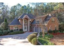Charming brick home with a well-manicured lawn and mature landscaping at 4763 River Hills Dr, Denver, NC 28037