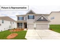 Charming two-story home with a two-car garage, a well-manicured lawn, and stone accents at 7015 Sylvan Retreat Dr, Denver, NC 28037