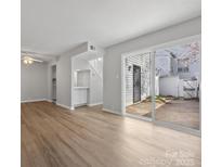 Bright living room featuring wood floors and sliding glass doors to the back patio at 7415 Mystic Ln, Charlotte, NC 28227