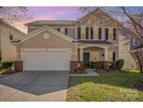 Inviting two-story home with a well-manicured lawn and blossoming tree at 9018 Seamill Rd, Charlotte, NC 28278