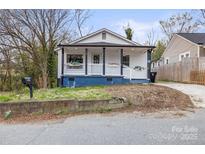 Charming home with a quaint front porch, black trim, blue accents, and inviting curb appeal at 98 Ring Sw Ave, Concord, NC 28025