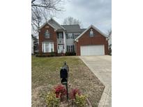 Charming two-story brick home with a well-manicured lawn and a two-car garage at 10607 Old Bridge Ln, Charlotte, NC 28269