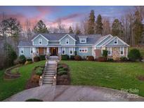 Stunning home with lush landscaping and a grand staircase leading to the welcoming front entrance at 1426 Merrimont Ave, Kings Mountain, NC 28086