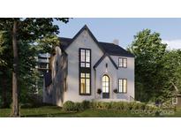 Charming two-story home with a well-manicured lawn and elegant arched doorway, creating a welcoming and stylish facade at 1645A Lombardy Cir, Charlotte, NC 28203