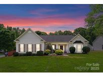 Charming single-story home with manicured lawn and landscaping in a tranquil setting at 196 Gabriel Dr, Mooresville, NC 28115
