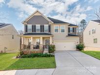 Charming two-story home features a welcoming front porch and a spacious two-car garage at 3449 Southern Red Oak Ln, Gastonia, NC 28056