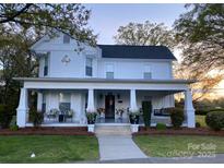 Charming home with a wide porch, swing, and landscaped front yard at 401 W Hoke St, Landis, NC 28088
