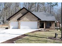 Charming brick home featuring an attached two-car garage and a well-manicured front lawn at 4531 Deer Run None, Rock Hill, SC 29732
