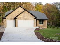 Charming brick home featuring a spacious driveway and well-manicured lawn at 4531 Deer Run None, Rock Hill, SC 29732
