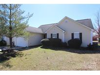 Charming single-story home featuring a manicured lawn and attached garage at 5809 Carolina Manor Ct, Indian Trail, NC 28079