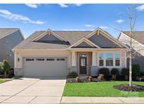 Charming single-Gathering home with a well-manicured lawn and attached two-car garage at 809 Cadence Park Pl, Fort Mill, SC 29708