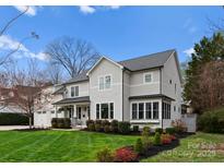 Stunning two-story home with a manicured lawn, charming landscaping and a white picket fence at 846 Wriston Pl, Charlotte, NC 28209