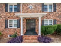 Charming brick home featuring a classic front entrance with black shutters and a well-manicured lawn at 912 Mcalway Rd # D, Charlotte, NC 28211