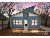 Charming blue home boasting a modern design and a welcoming entrance with black trim windows, enhancing curb appeal at 913 Wilson W Lee Blvd, Statesville, NC 28677