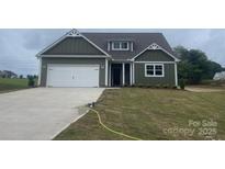 Charming craftsman-style home with an attached garage, well-manicured lawn, and beautiful curb appeal at 11533 Valley Oaks Ln, Stanfield, NC 28163