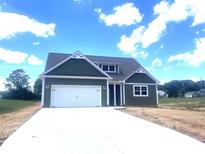 Charming single-Gathering home with a two-car garage and a well-manicured lawn at 11533 Valley Oaks Ln, Stanfield, NC 28163