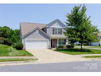 Charming two-story home with a well-manicured front lawn and attached two-car garage at 137 Mossy Pond Rd, Statesville, NC 28677