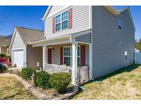 Inviting home with a charming front porch and well-maintained landscaping at 137 Mossy Pond Rd, Statesville, NC 28677