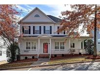 Charming two-story home with a covered front porch and mature trees in a desirable neighborhood at 226 Fairview Ln, Davidson, NC 28036
