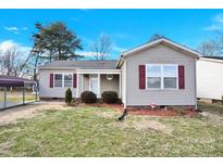 Charming single-story home with vinyl siding, red shutters, and a well-maintained front yard at 340 Vernon Ln, Statesville, NC 28677