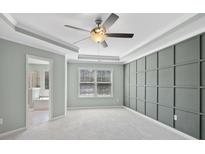 Spacious main bedroom featuring a decorative wall panel and a ceiling fan at 3441 Scottish Fern Ln, Indian Land, SC 29707