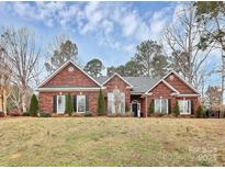 Charming brick home with manicured lawn and mature trees, offering classic curb appeal at 3615 Wild Rose Ct, Matthews, NC 28104