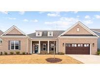 Charming brick home featuring an attached garage and a well-manicured lawn at 4034 Sagemont Nw Dr, Concord, NC 28027