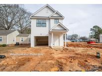 New construction home featuring white siding, a garage, and a covered front entrance at 504 Sharpe St, Mooresville, NC 28115