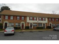 Charming townhome with brick facade, covered entrances, and well-maintained landscaping at 6354 Old Pineville Rd # A, Charlotte, NC 28217