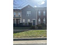 Attractive two-story townhome featuring a well-manicured lawn and a charming front entry at 128 Locomotive Ln # 110, Mooresville, NC 28115