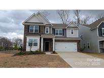 Charming two-story home featuring a brick and siding facade with an attached two-car garage at 14705 Superior St, Charlotte, NC 28273