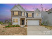 Charming two-story home with brick and gray siding, a two-car garage, and landscaped front yard at 14705 Superior St, Charlotte, NC 28273