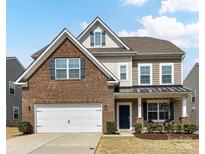 Charming two-story home with brick and vinyl siding, a well-maintained lawn, and an attached two-car garage at 15954 Harbor Hill Dr, Charlotte, NC 28273