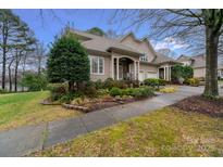 Charming home featuring well-manicured landscaping and a welcoming front porch with stately columns at 18845 Cloverstone Cir, Cornelius, NC 28031