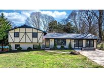 Charming home with a well-manicured lawn, elegant brickwork, and stylish black trim accents at 2530 31St Street Ne Dr, Hickory, NC 28601