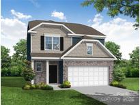 Charming two-story home featuring stone accents, a two-car garage, and a beautifully landscaped front yard at 2809 Ashton Park Ln # 72, Monroe, NC 28110