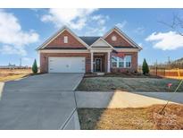 Charming single-story brick home with a two-car garage and manicured lawn at 3069 Founding Fathers Dr # 38, Gastonia, NC 28056