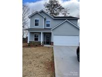 Two-story home featuring a two-car garage, gray siding and black front door at 3258 Killian Rd, Lincolnton, NC 28092