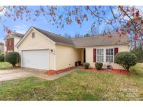 Charming single-story home with a well-maintained lawn and colorful landscaping at 6708 Burning Oak Ln, Charlotte, NC 28216