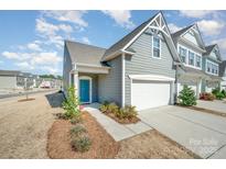 Charming home features a bright blue front door and a one car garage at 8573 River Ridge Dr, Charlotte, NC 28213