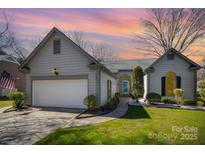 Charming home with a well-manicured lawn, two car garage, and welcoming curb appeal at 9200 Four Acre Ct, Charlotte, NC 28210