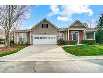 Charming single-Gathering home featuring a two-car garage and brick-accented entryway at 10011 Forest View Ln, Charlotte, NC 28213