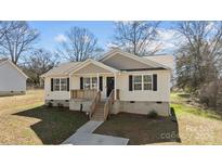 Charming single-story home with welcoming porch, well-manicured lawn, and tasteful landscaping at 1707 W 4Th Ave, Gastonia, NC 28052