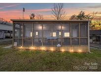 Charming screened porch with wood accents and welcoming lighting, perfect for relaxing outdoors at 171 Holly Harbor Trl # B62, Mount Gilead, NC 27306