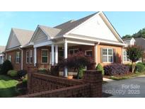 Inviting single-story brick home with manicured landscaping and a welcoming front porch at 2227 Cashmere Ct, Denver, NC 28037