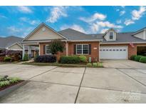 Brick home with a two-car garage and lovely landscaping at 2227 Cashmere Ct, Denver, NC 28037