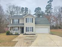 Charming two-story home with a well-manicured lawn, a front porch and an attached garage at 2766 Stagbuck Dr, Gastonia, NC 28052