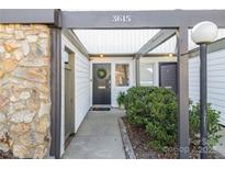 Inviting front entrance featuring a black front door, stone wall accents, and well-maintained landscaping at 3615 Maple Glenn Ln, Charlotte, NC 28226