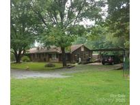 Ranch home featuring mature trees, and covered carport with parking at 410 Yadkin St, Salisbury, NC 28146