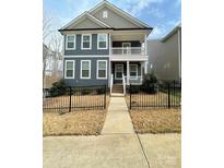 Charming two-story home with a covered front porch and a well-manicured lawn at 615 R L Stowe Rd, Belmont, NC 28012